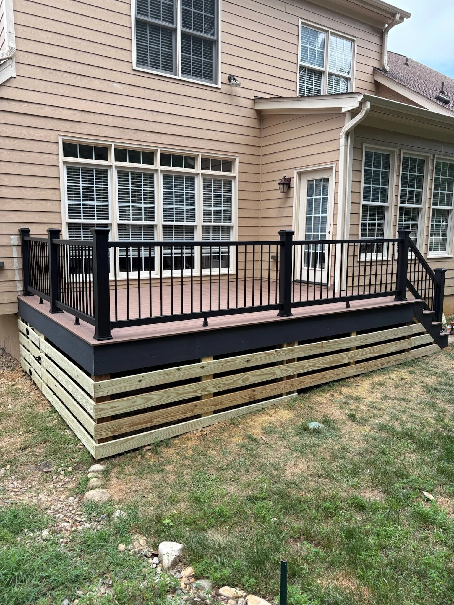 Replaced old wood deck with a Deckorators Summit composite deck and Trex Enhance railing