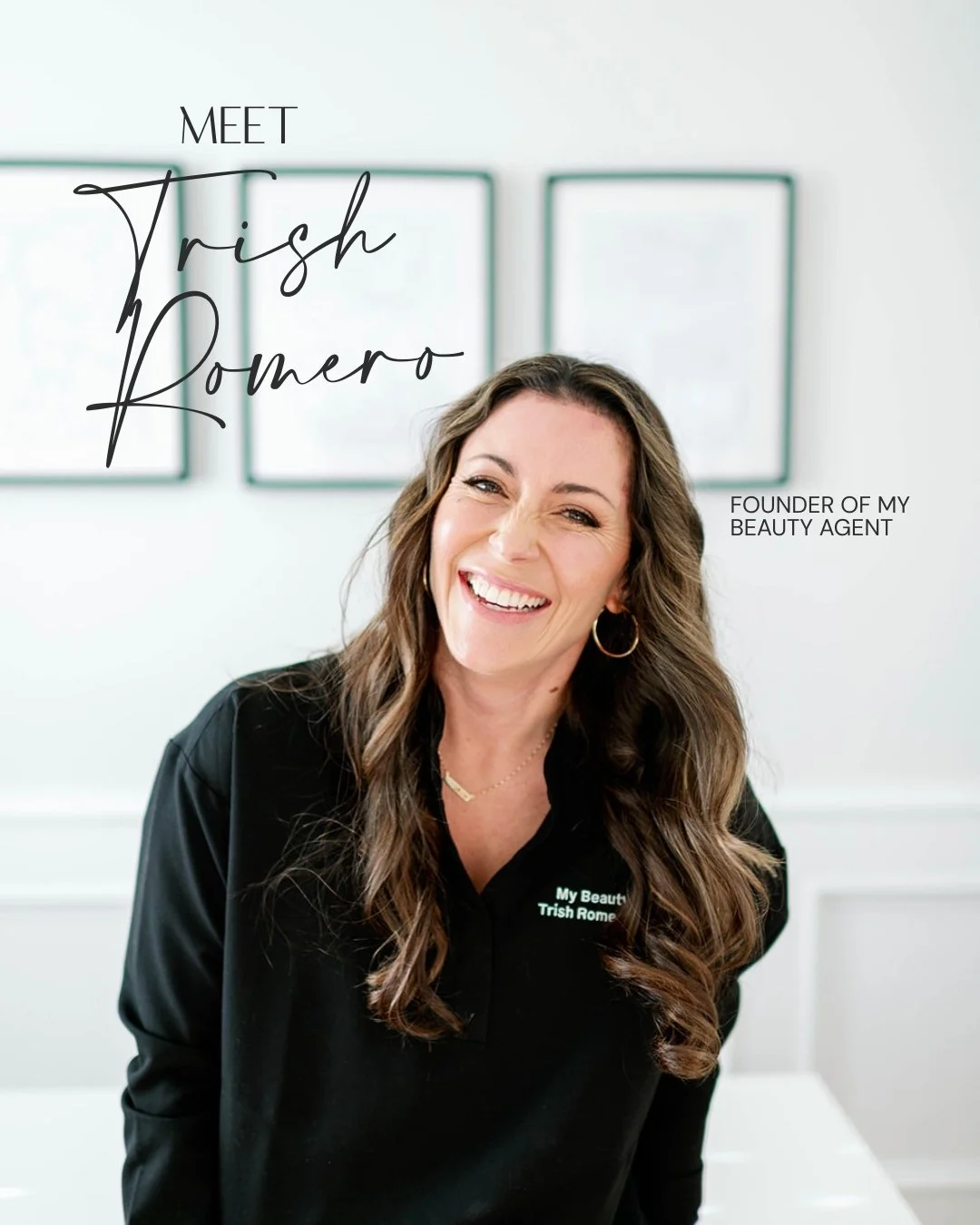 Portrait of Trish Romero, founder of My Beauty Agent, smiling and wearing a black shirt with green embroidered text, in a bright room with framed art on the wall behind her.