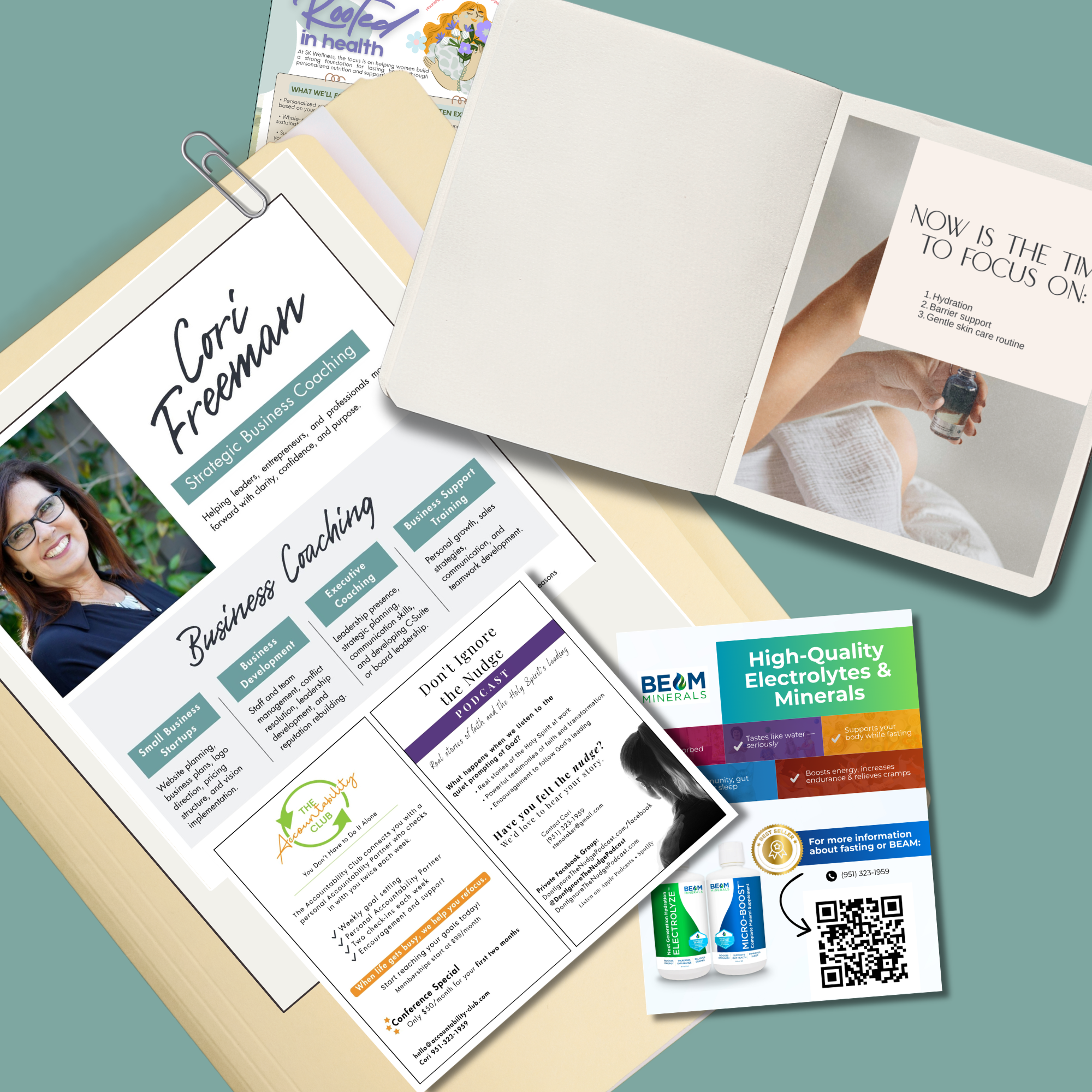 An assortment of printed marketing and informational materials displayed on a flat surface, including a business card for Cori Freeman, a brochure for BEAM Minerals, a flyer for health support, and a booklet about health and skincare routine.