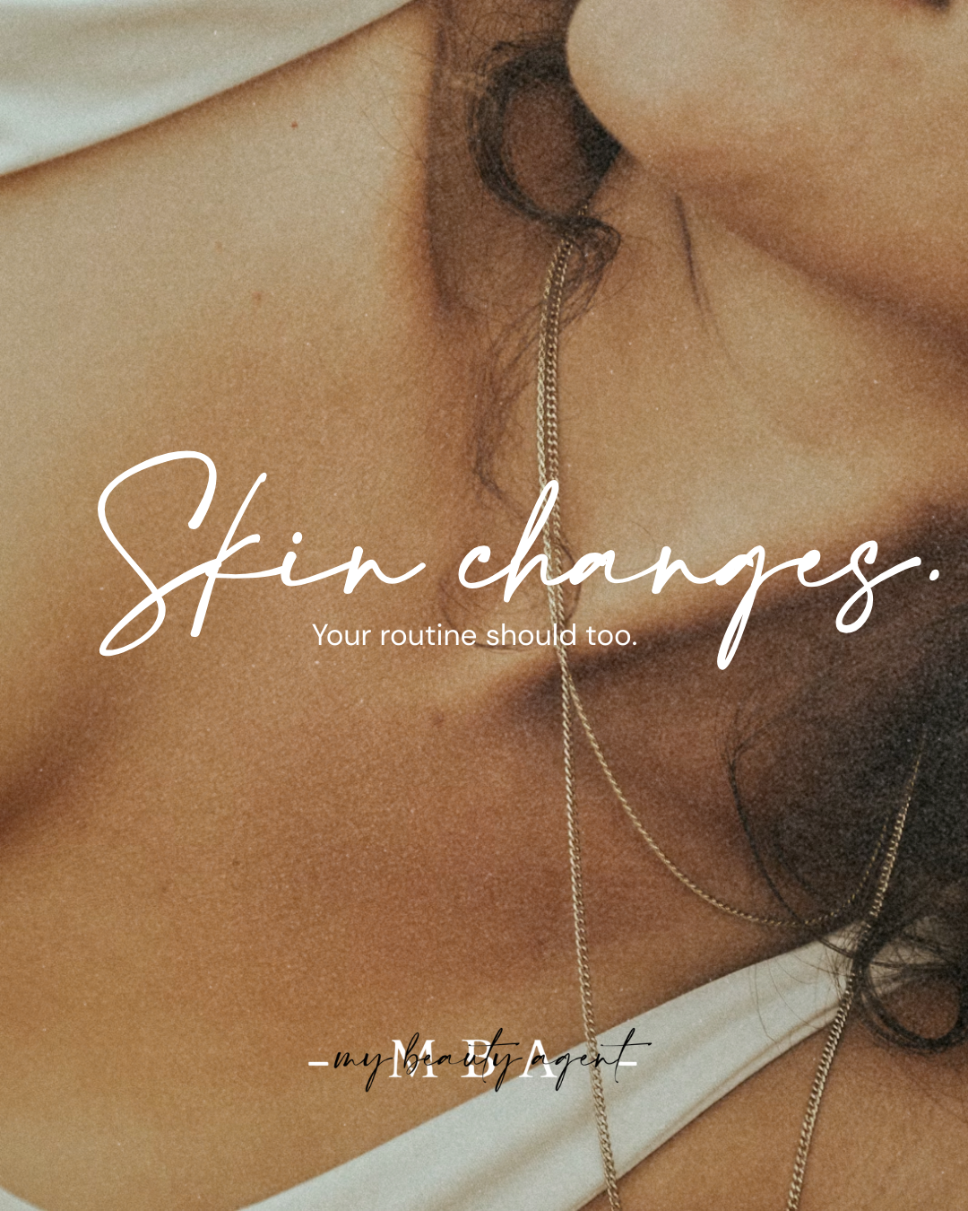 Close-up of a woman's neck with layered gold necklaces and dark wavy hair, overlaid with white cursive text that reads 'Skin changes.' followed by smaller text 'Your routine should too.' and '- my BeaT A gen'.