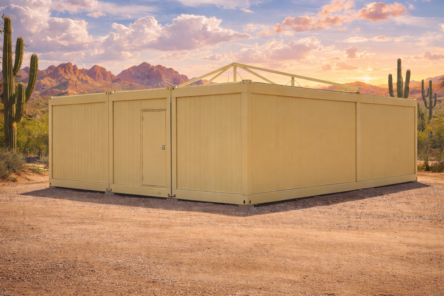 A yellow metal storage container in a desert landscape with cacti and mountains at sunset.