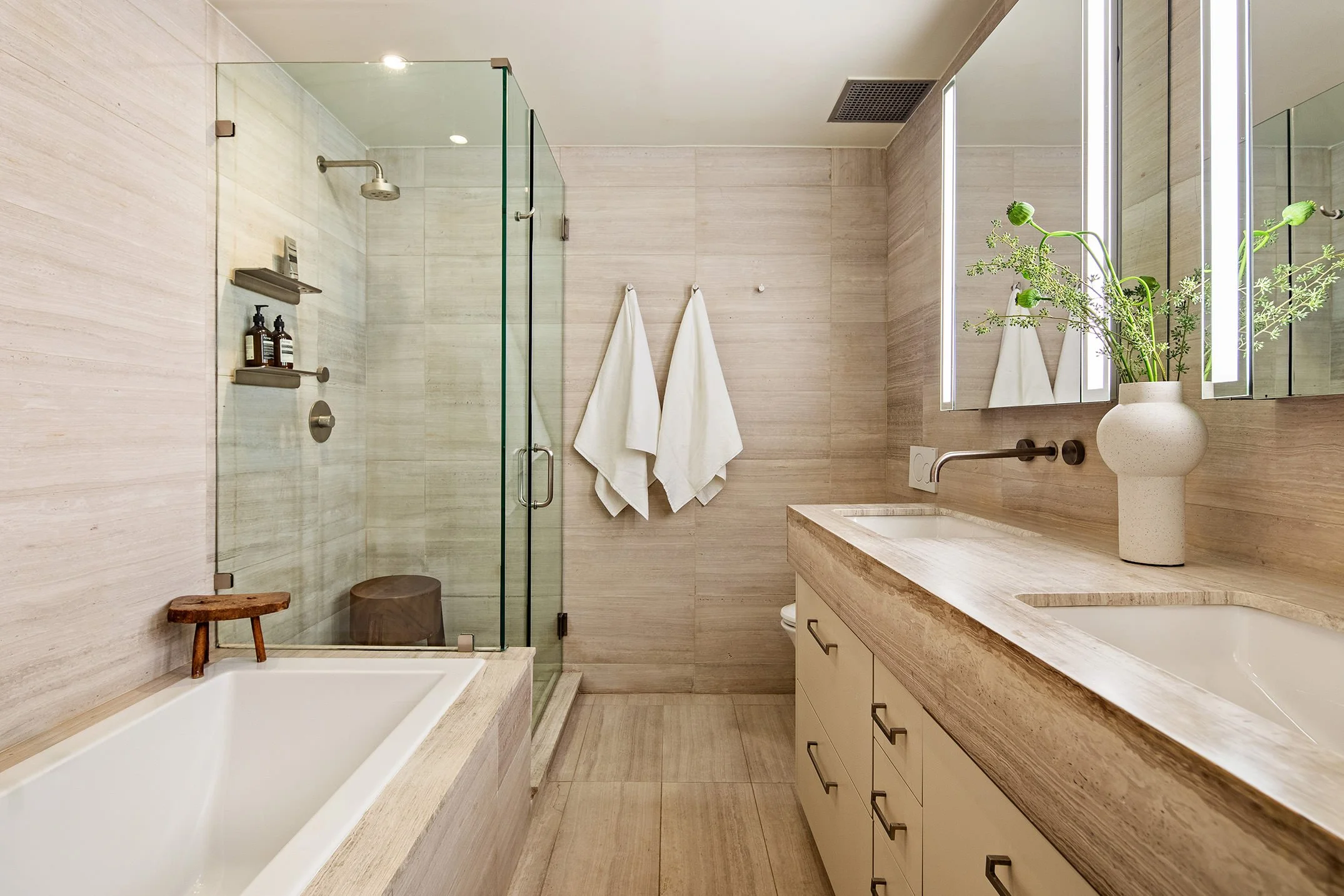  grey full toned bathroom with a full bathtub and a clear glass shower 