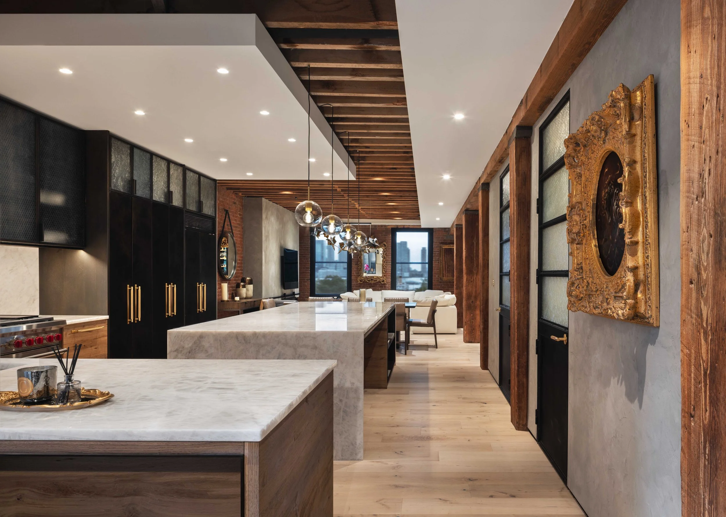  white marble countertops in large living room area with dark cabinetry 