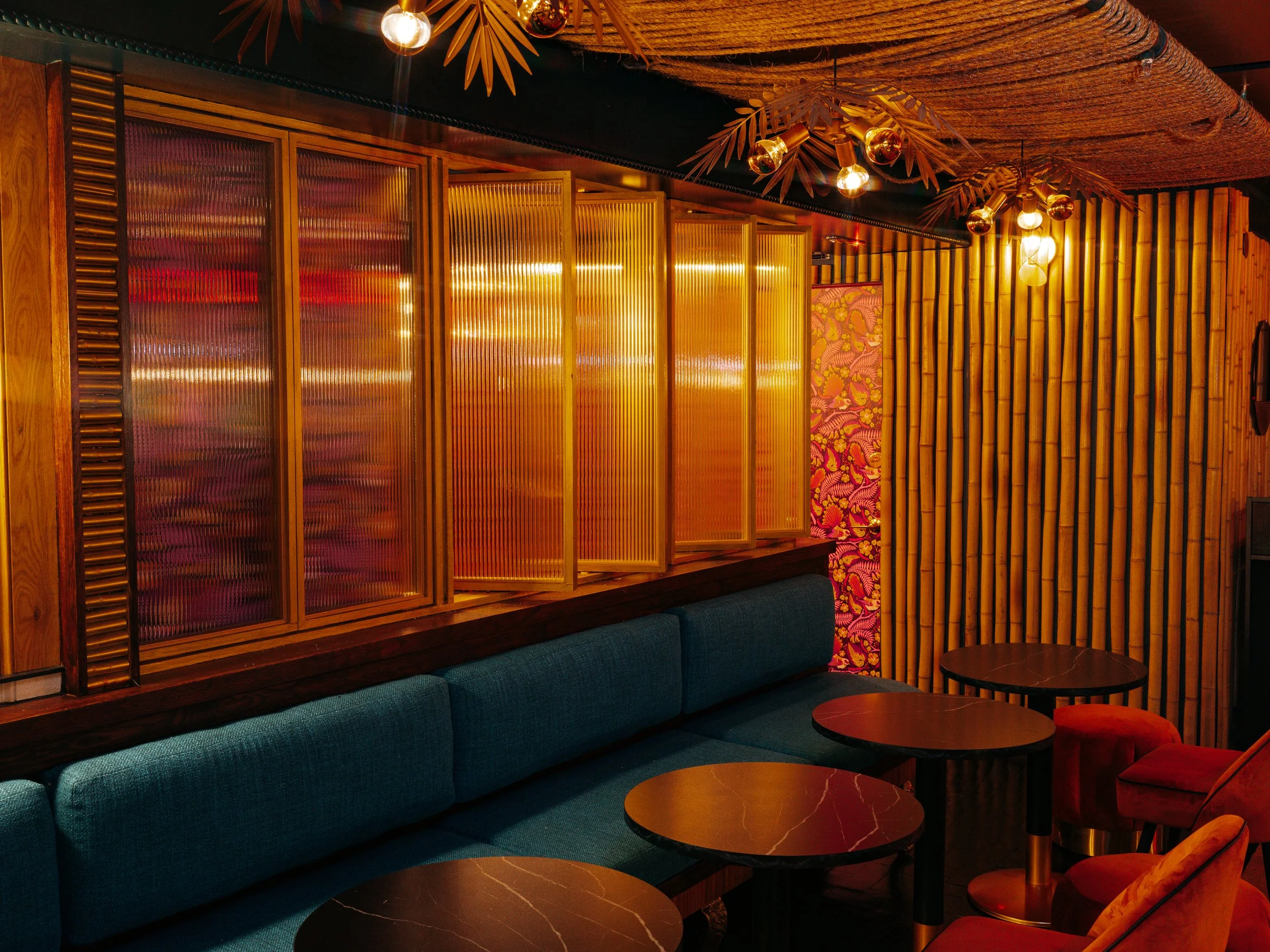  warm lit restaurant with blue accent couches 