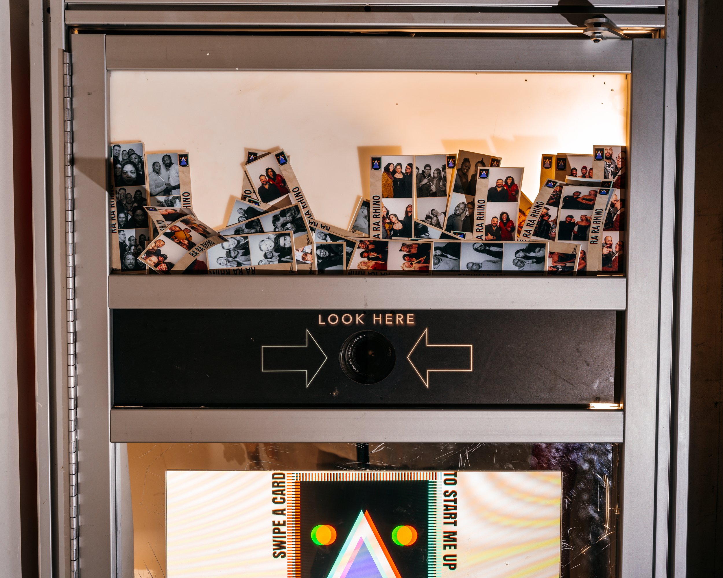  interior of vintage photo booth that shows example images and the photo lens 
