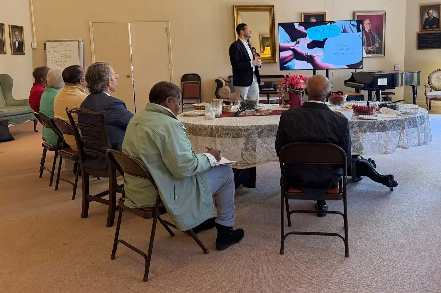 Photo of ABHMS national coordinator for Latino Ministries Rev. Abner Cotto-Bonilla (standing in background) conducts a seminar at AB Churches of Connecticut regional gathering.