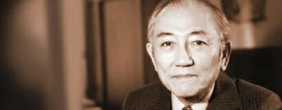 A portrait of an older man with short, light-colored hair, wearing a dark jacket, looking at the camera in a neutral expression.