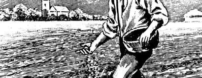 Person with rolled-up sleeves reaching into water at the riverbank with buildings and trees in the background.