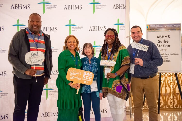Photo of attendees at Space for Grace 2026 mugging at the selfie station.