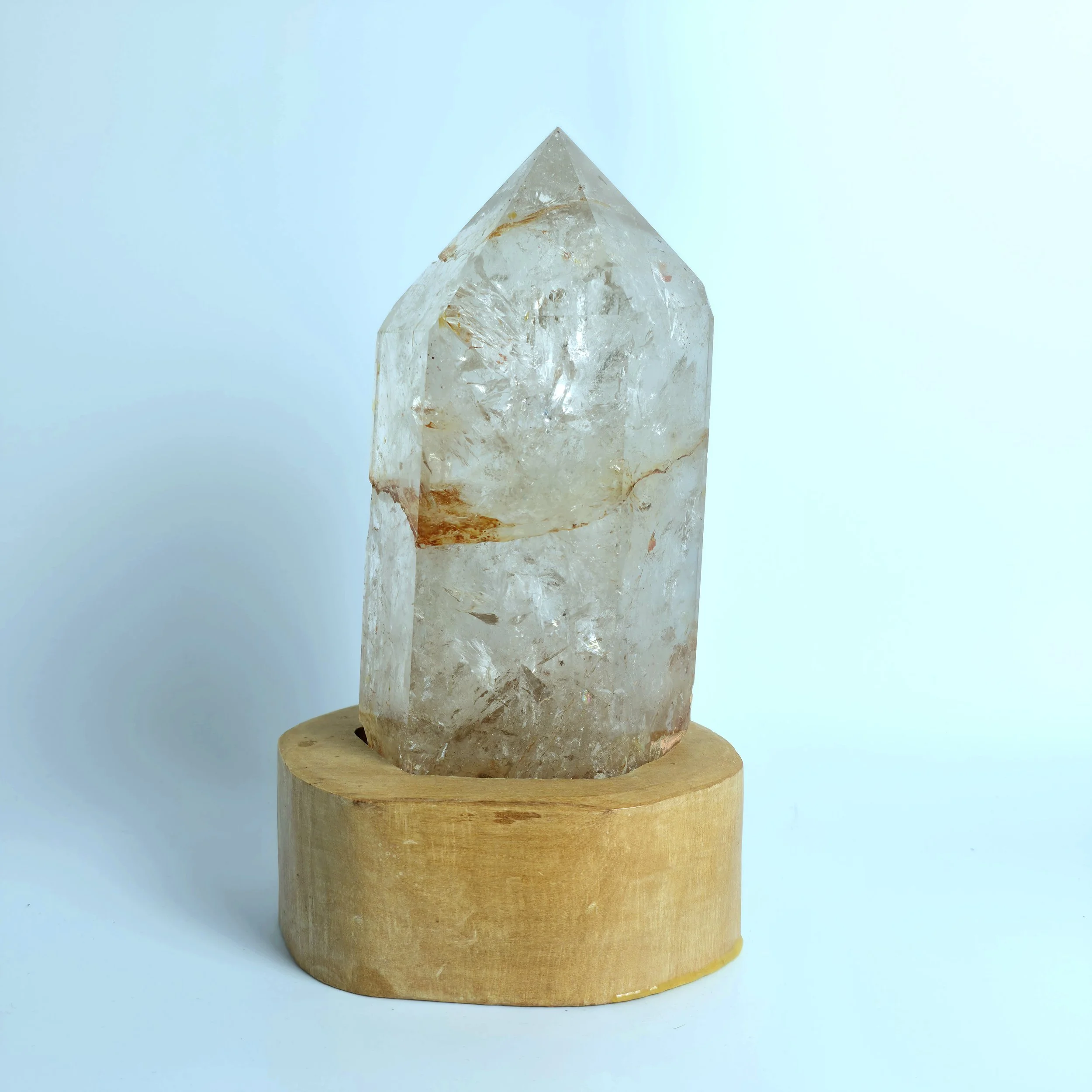 Clear Quartz Point w/Hematite Inclusions on Wood Stand