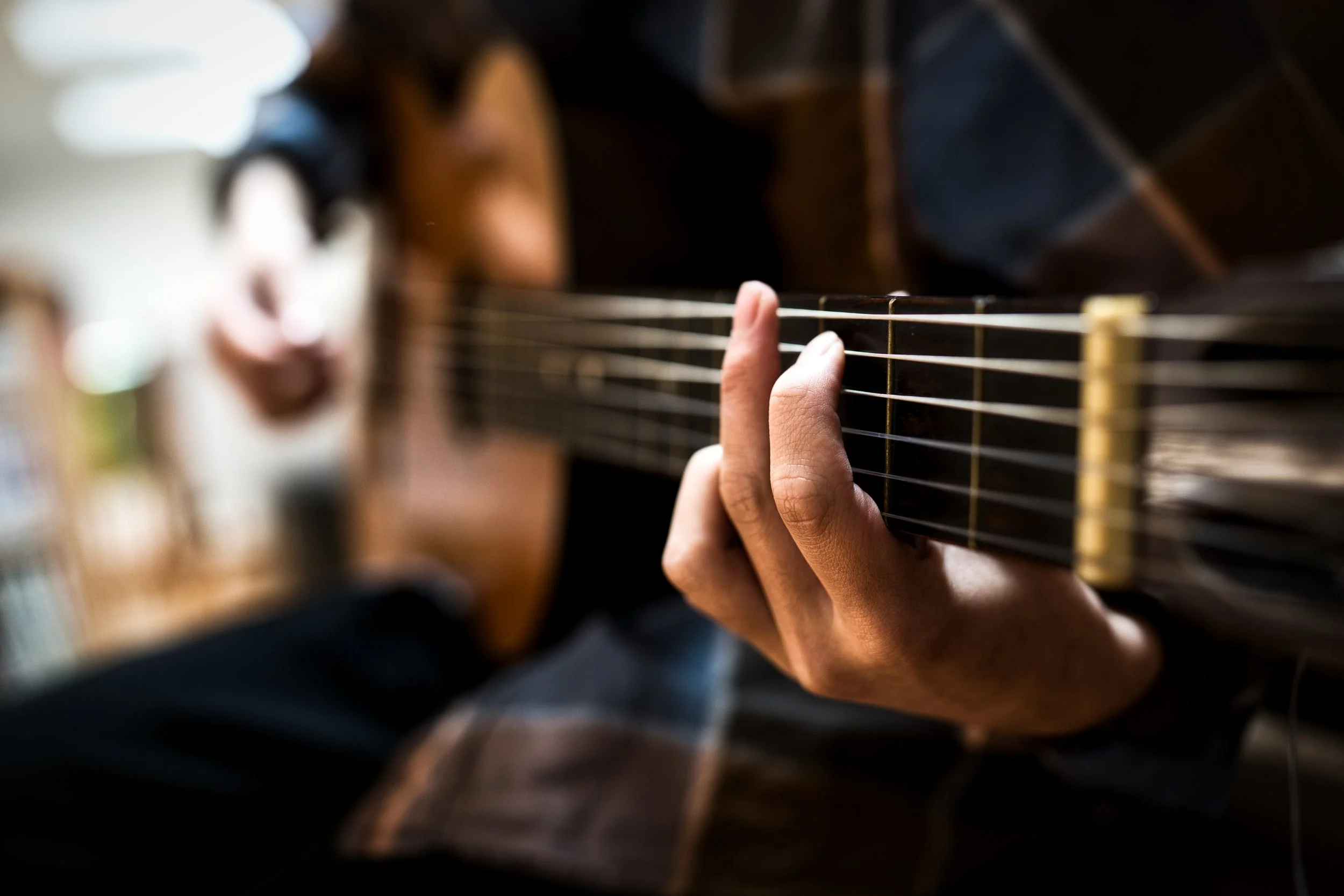 A person playing an acoustic guitar