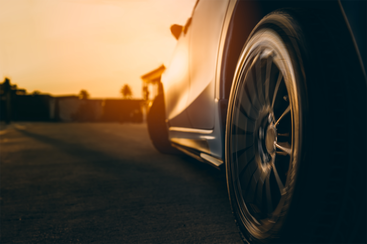 Car on a race track at sunset