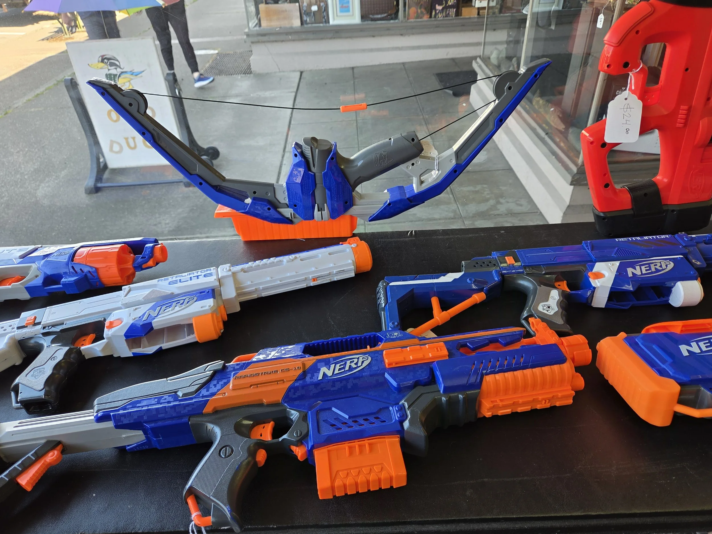 a table featuring colorful Nerf guns and a Nerf bow