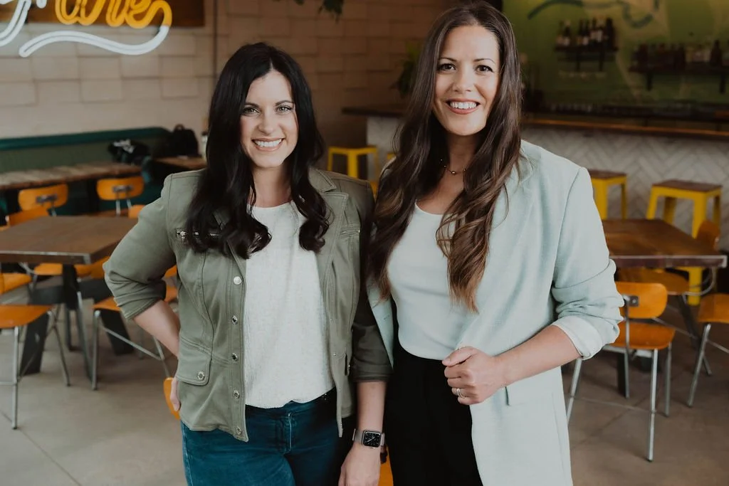 Keri Hinterreiter and Erin Hildmann smiling together, co-founders of The Collective for Designers.