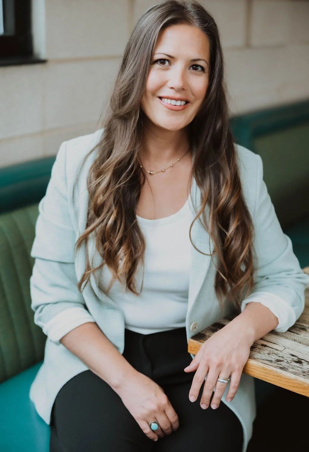 Erin Hildmann, cofounder of the collective for designers sits posed for the camera smiling at the viewers
