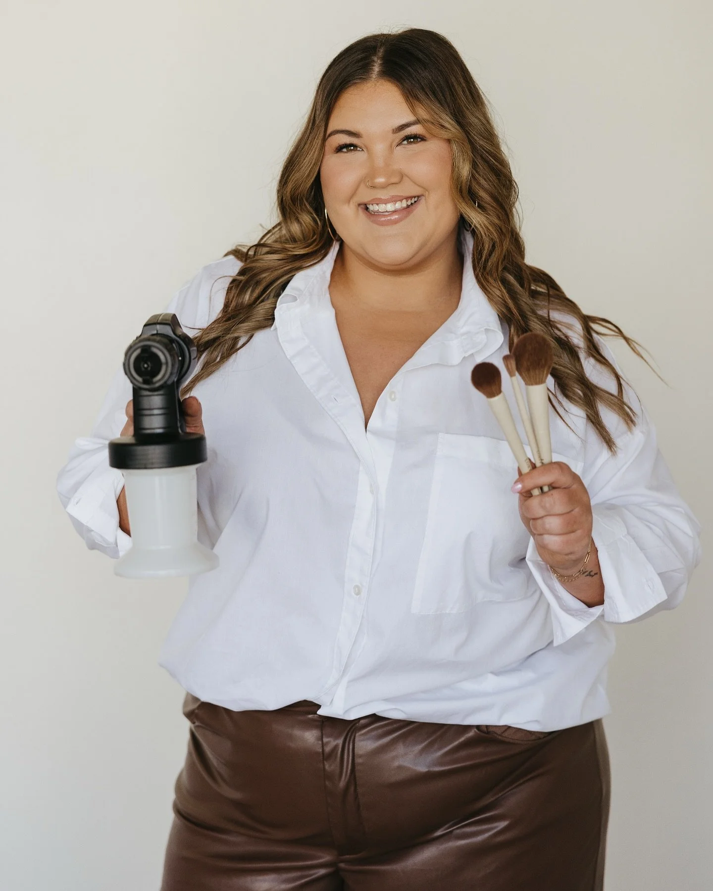 Morgan posting with spray gun and makeup brushes