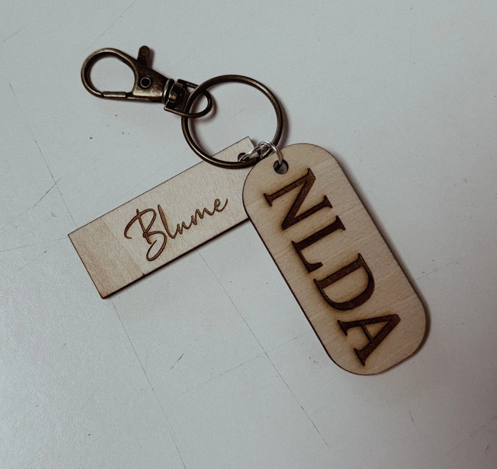 2-piece wooden keychain with custom laser engraved and a clip. 