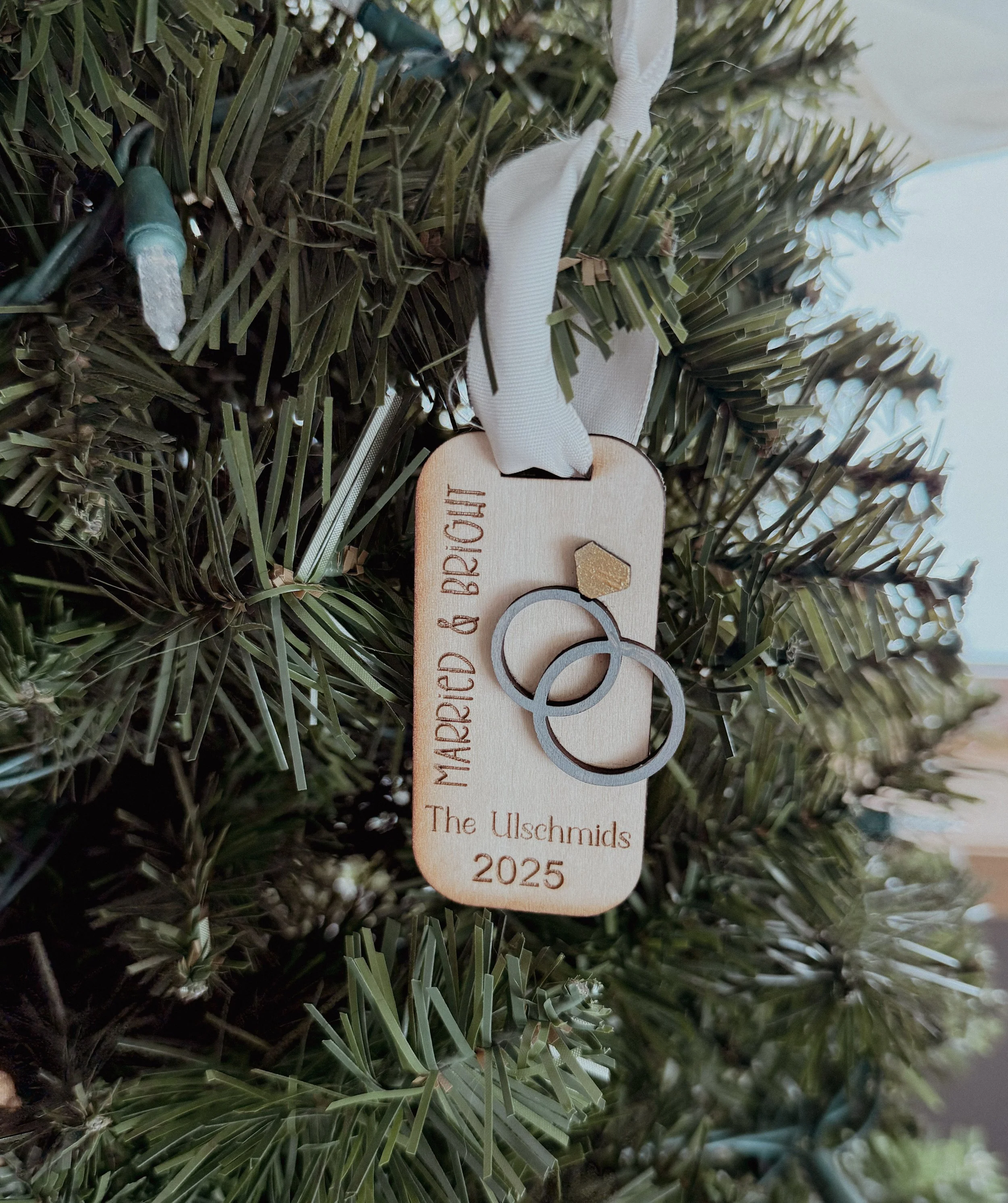 Small Christmas ornament for couples. Says "married & bright" with custom last name and date. Has added cut-out rings, hand-painted. 