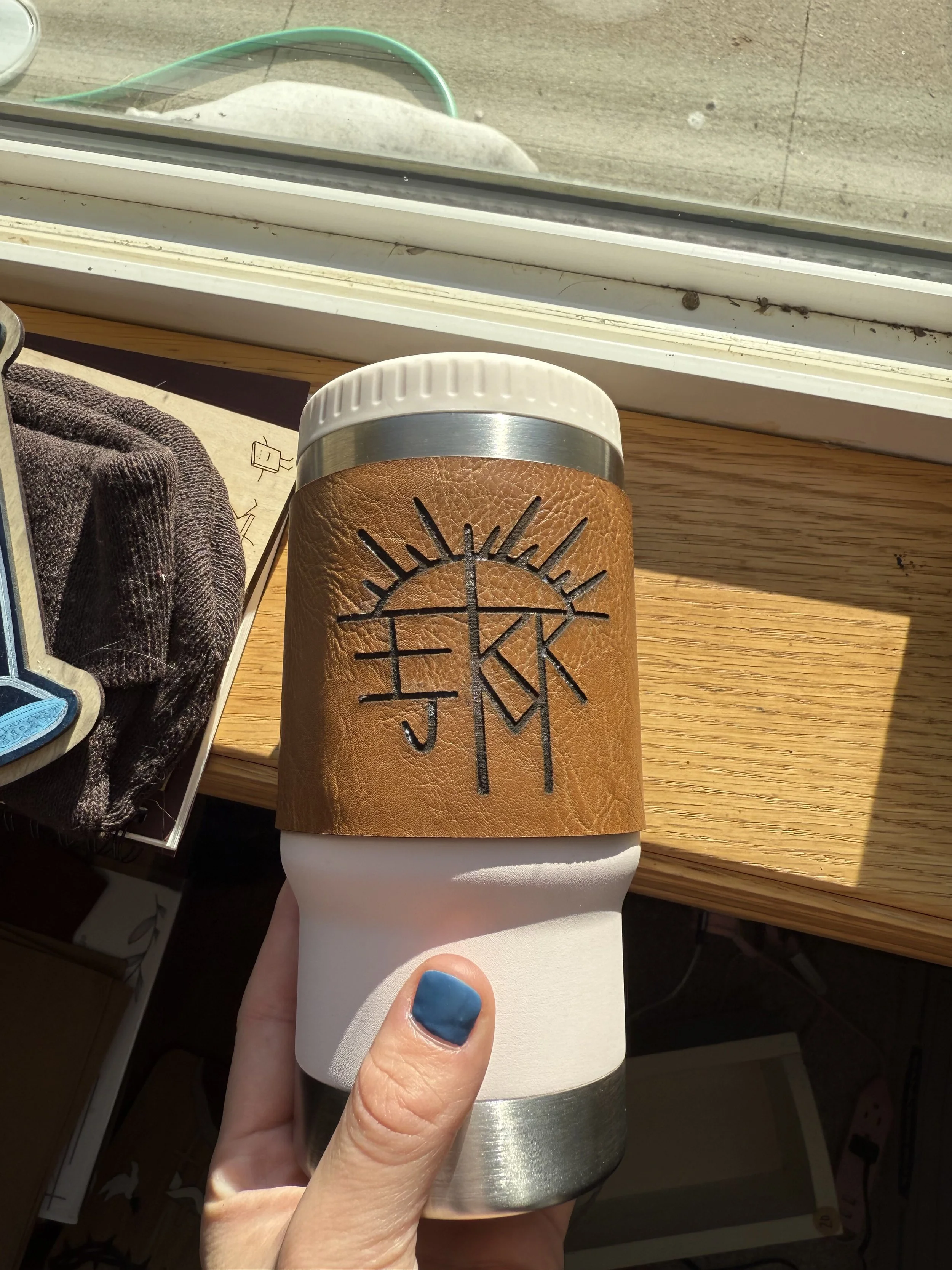 Light brown leather koozie with custom artwork, fit to the specific cup per customer request. 