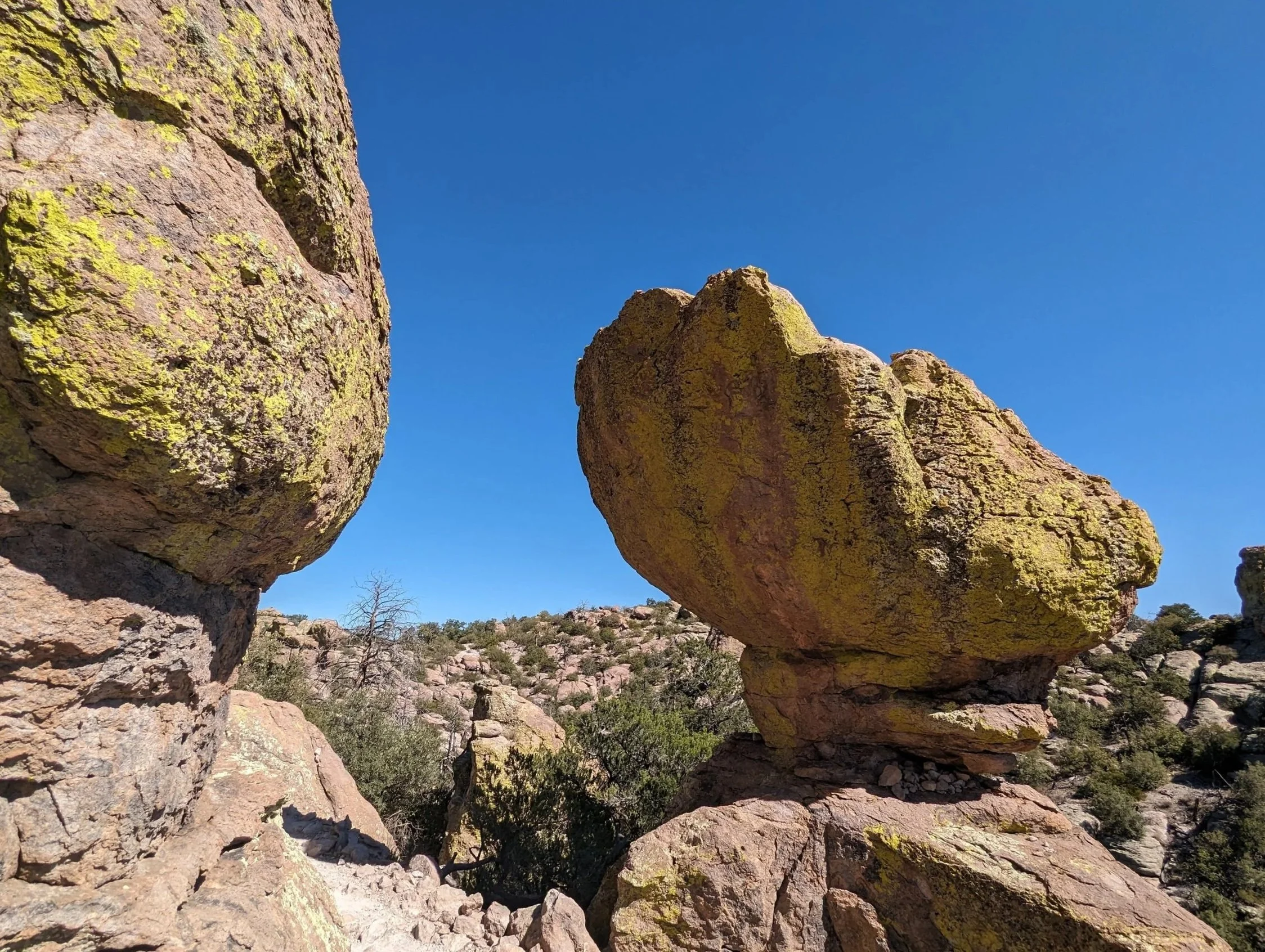 Large rocks in a desert landscape with a clear blue sky