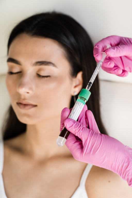 Person receiving a medical injection with a syringe from a healthcare professional wearing pink gloves.