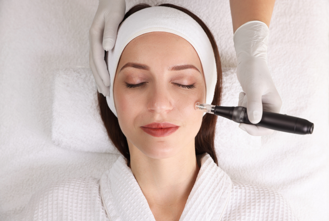 A woman receiving a facial treatment with a micropigmentation device at a spa