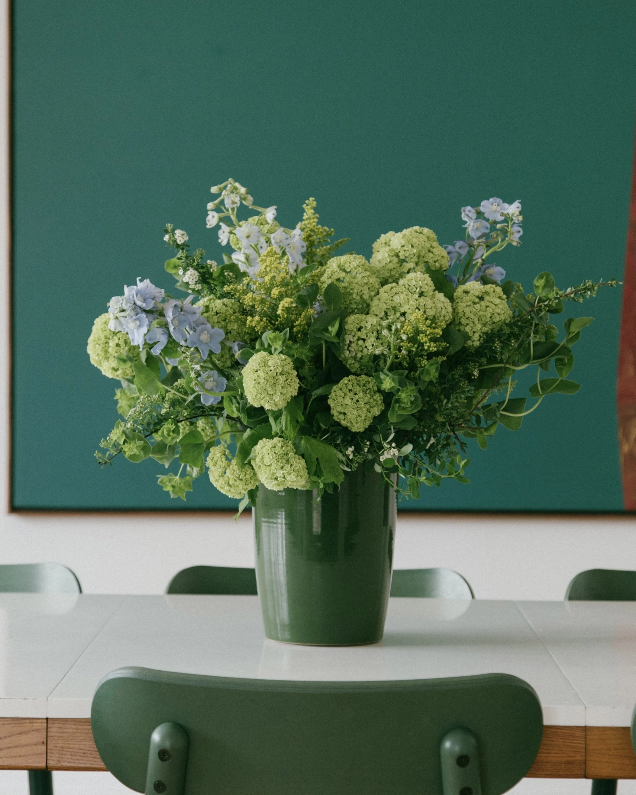 Green vase featuring an arrangement for my wedding by Grasslands Flower Co. - 2022