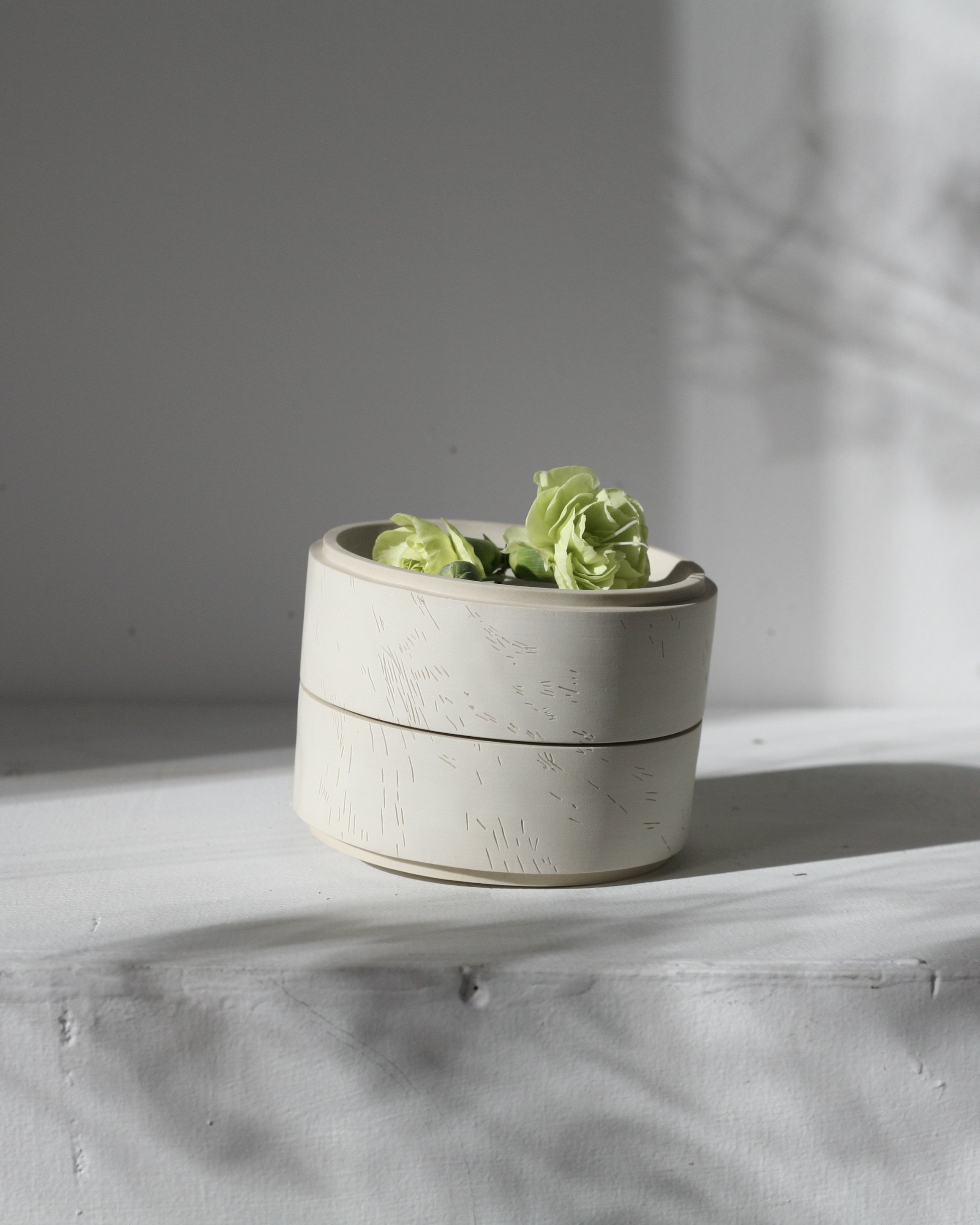 The urn can sit on either end. One of them stable and unmoving, the other inviting you to interact with it in ritual by placing flowers or other meaningful objects in its bowl, and gently spinning it on its point - 2018