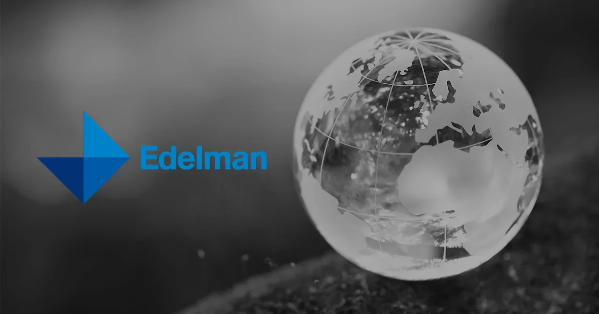 A company logo for Edelman next to a glass globe showing a map of the world, with a black and white background.