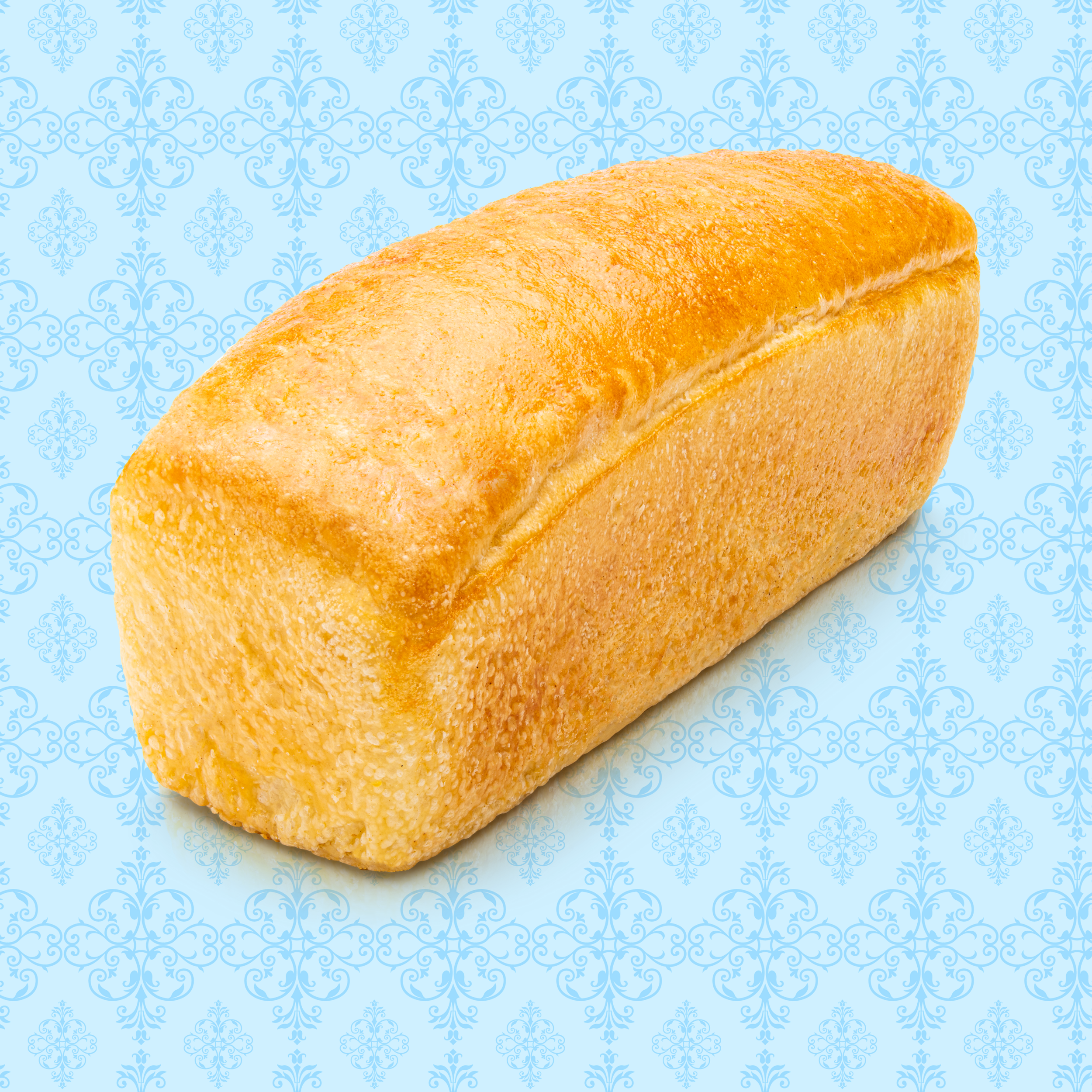 Loaf of bread on a light blue decorative patterned background.