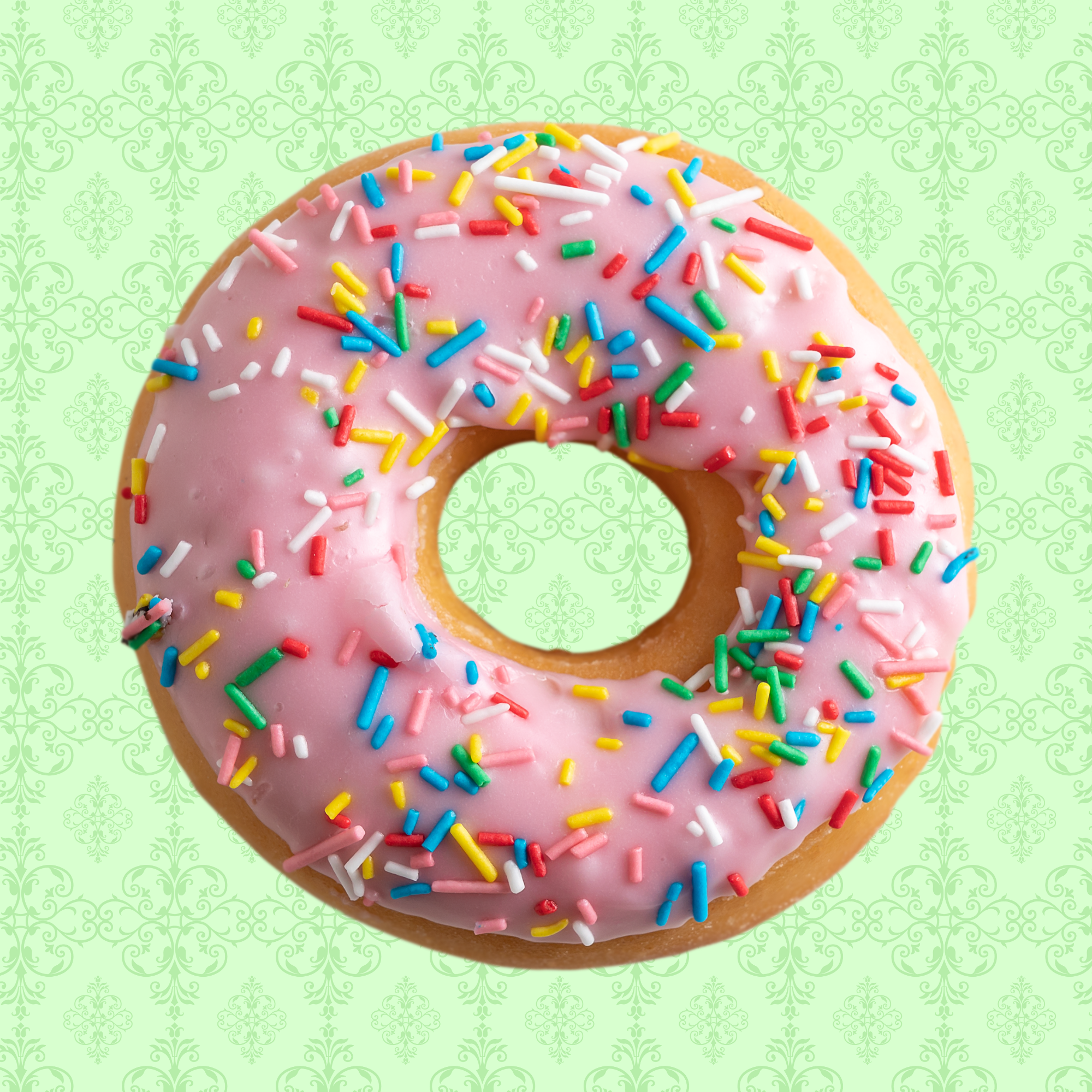 A donut with pink frosting and colorful sprinkles on a decorative green background.