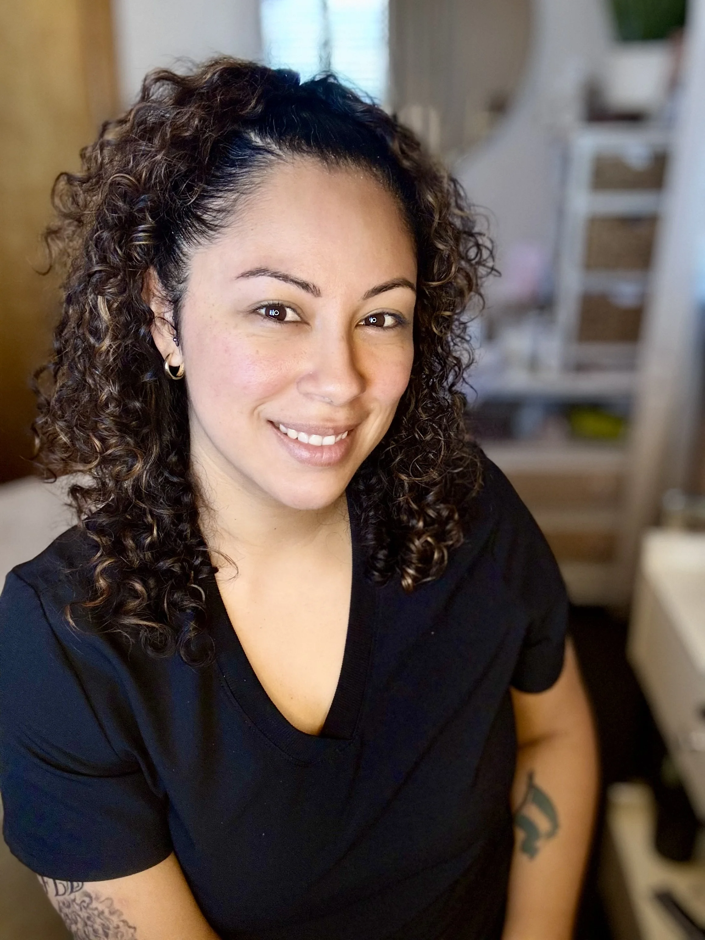 Stephanie Collin-Cano, licensed esthetician at Soul Shine Skincare in Brownsburg, standing in her warm and welcoming treatment room.