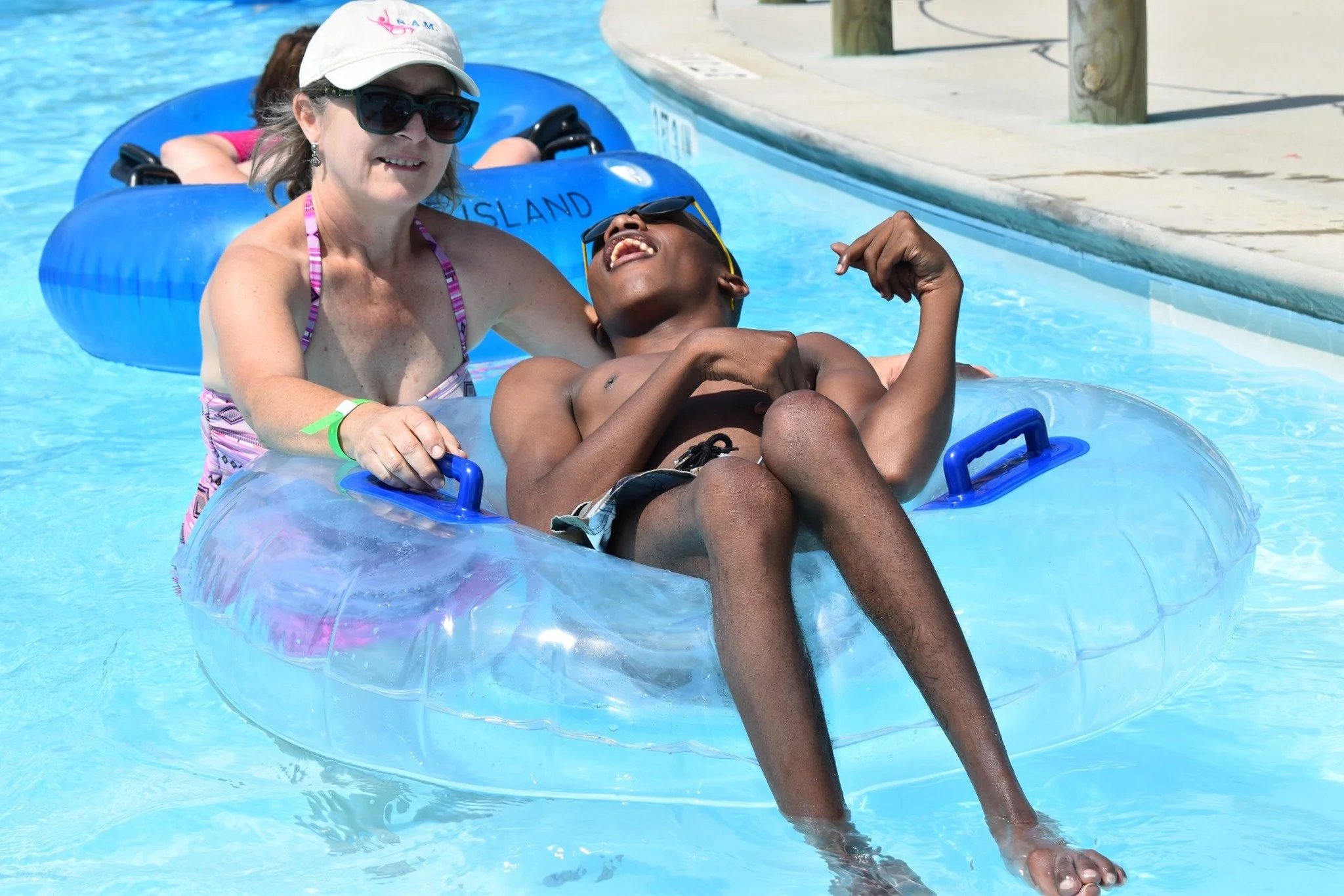 A camper getting pushed in a float over the water