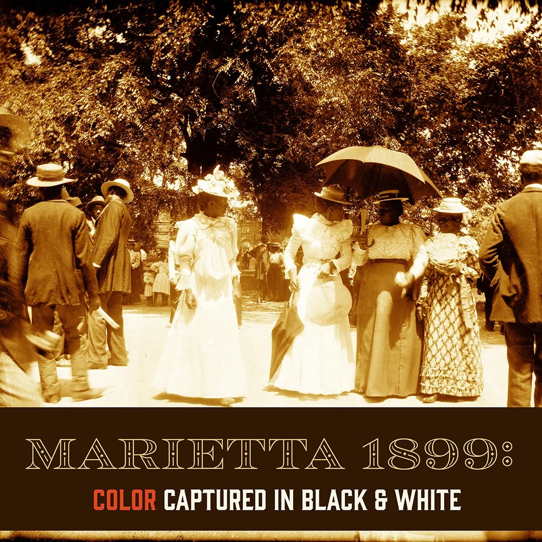Sepia-tone historical photograph of men and women dressed in late 19th-century attire in Marietta, dating from 1899, with women wearing long skirts and hats, and men in suits and hats, standing and walking in a park-like setting.
