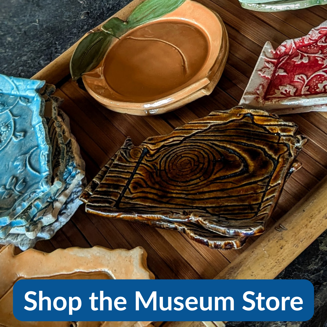 Colorful ceramic plates with intricate patterns on a wooden surface.