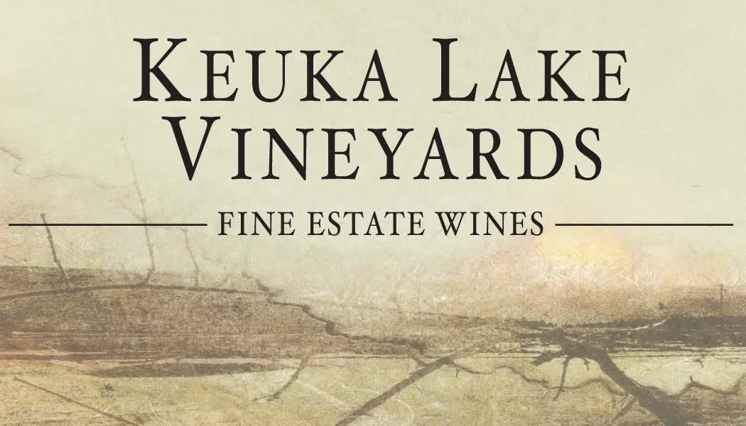 Label for Keuka Lake Vineyards featuring the text, 'Keuka Lake Vineyards, Fine Estate Wines' on a background resembling a vineyard or natural setting.