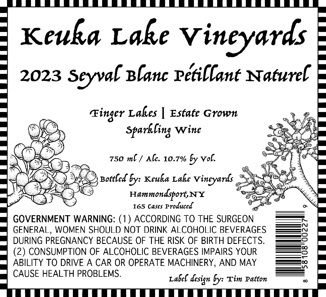 Label for Keuka Lake Vineyards 2023 Seyval Blanc pétillant naturel sparkling wine, with illustrations of grape clusters on the left and right sides, black and white striped border, and text providing product details and health warnings.