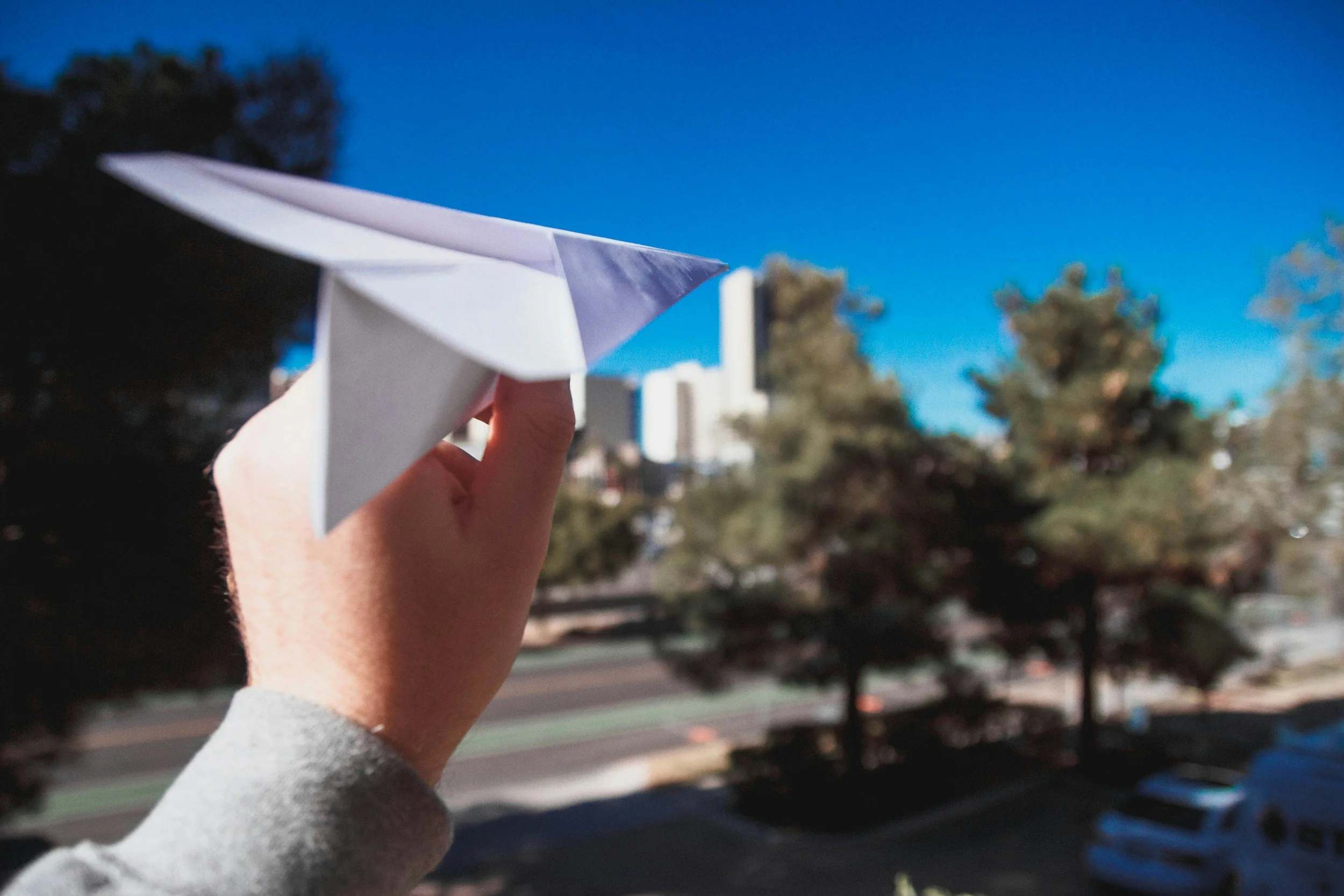 Paper airplane flying forward, symbolizing proactive, forward-thinking IT support for small businesses.