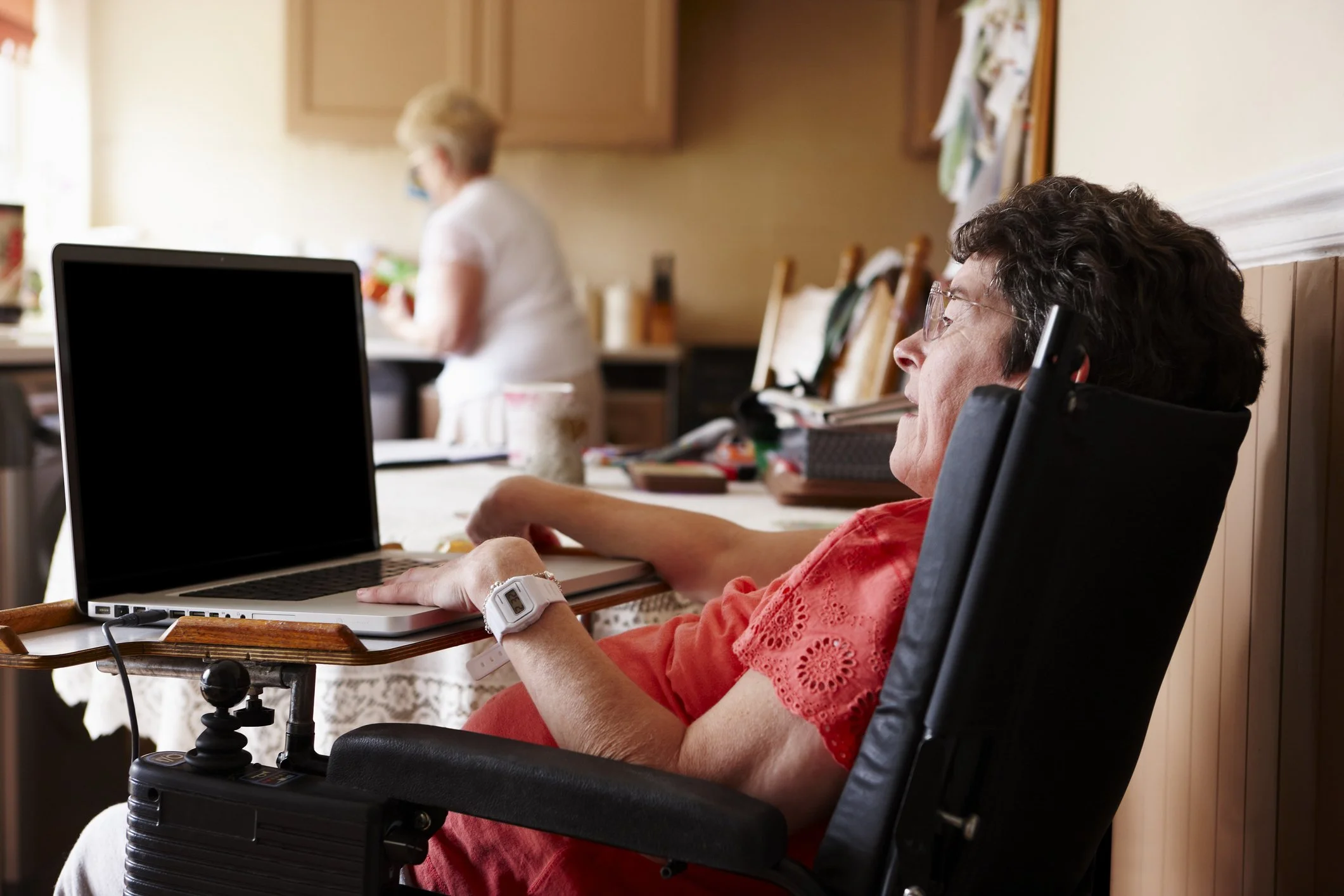 Woman in wheelchair at table