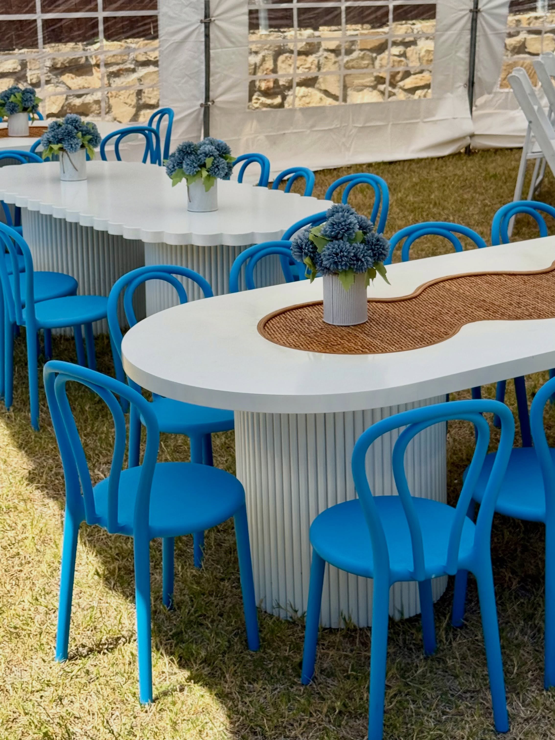When the table is already the statement. 💙
No tablecloths. No over-styling. Just beautiful kids&rsquo; tables, bold blue Loop Chairs, scalloped edges and warm rattan details doing the work.
Our Pearl + Scallop Tables are designed to be part of the d