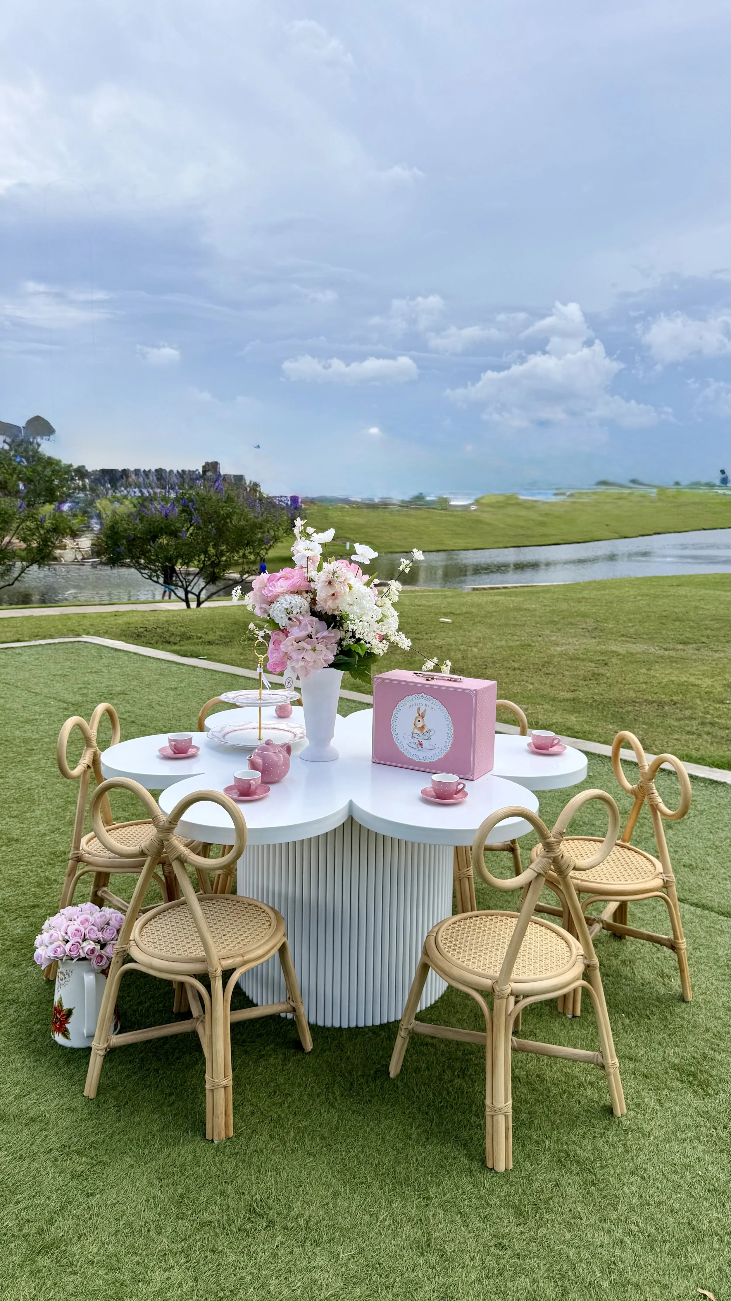 White flower table and bow chairs on grass