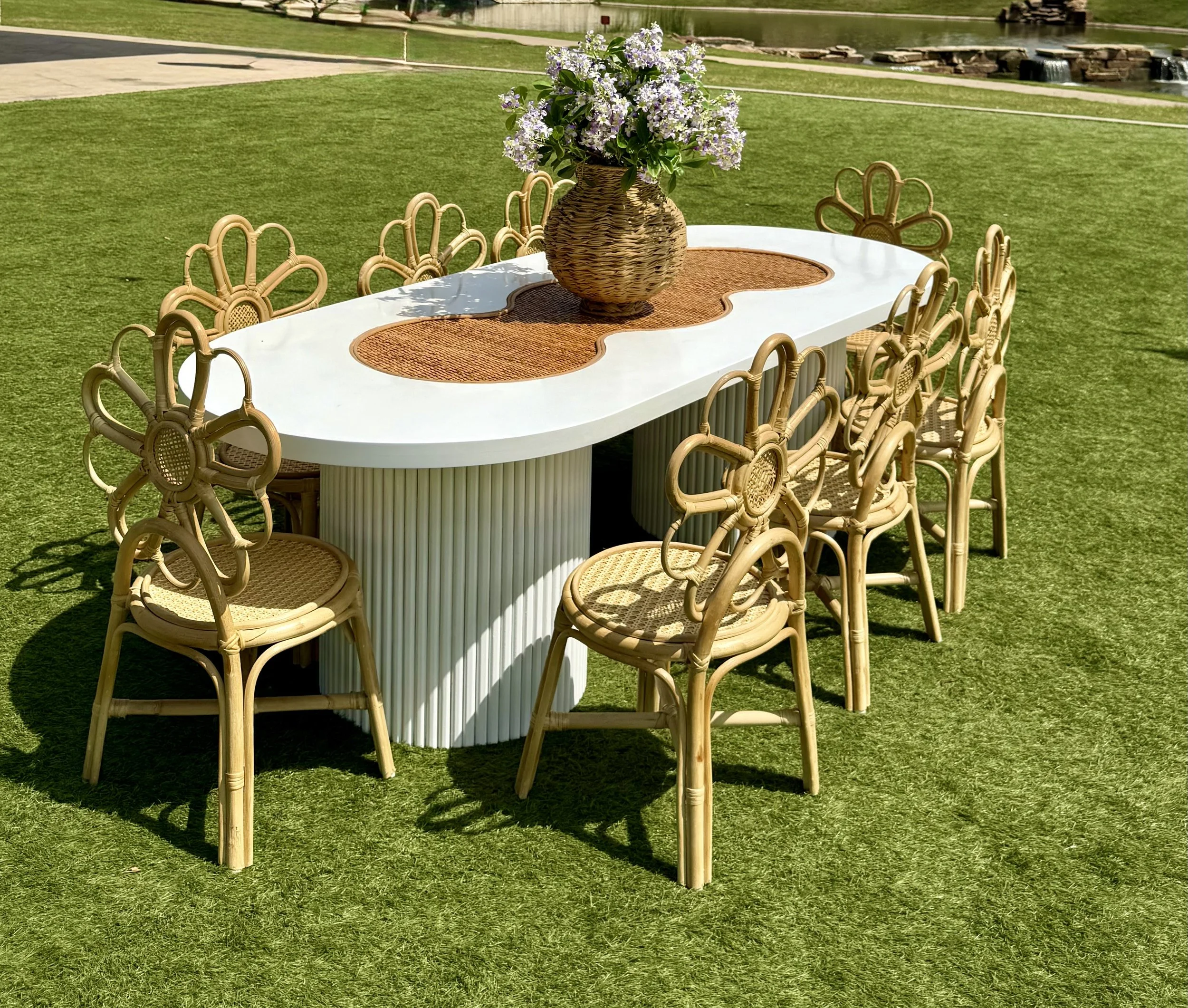White raffia oval table with daisy flower chair