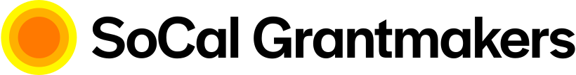 The SoCal Grantmakers logo featuring a yellow sun icon with a red inner circle on a black background.