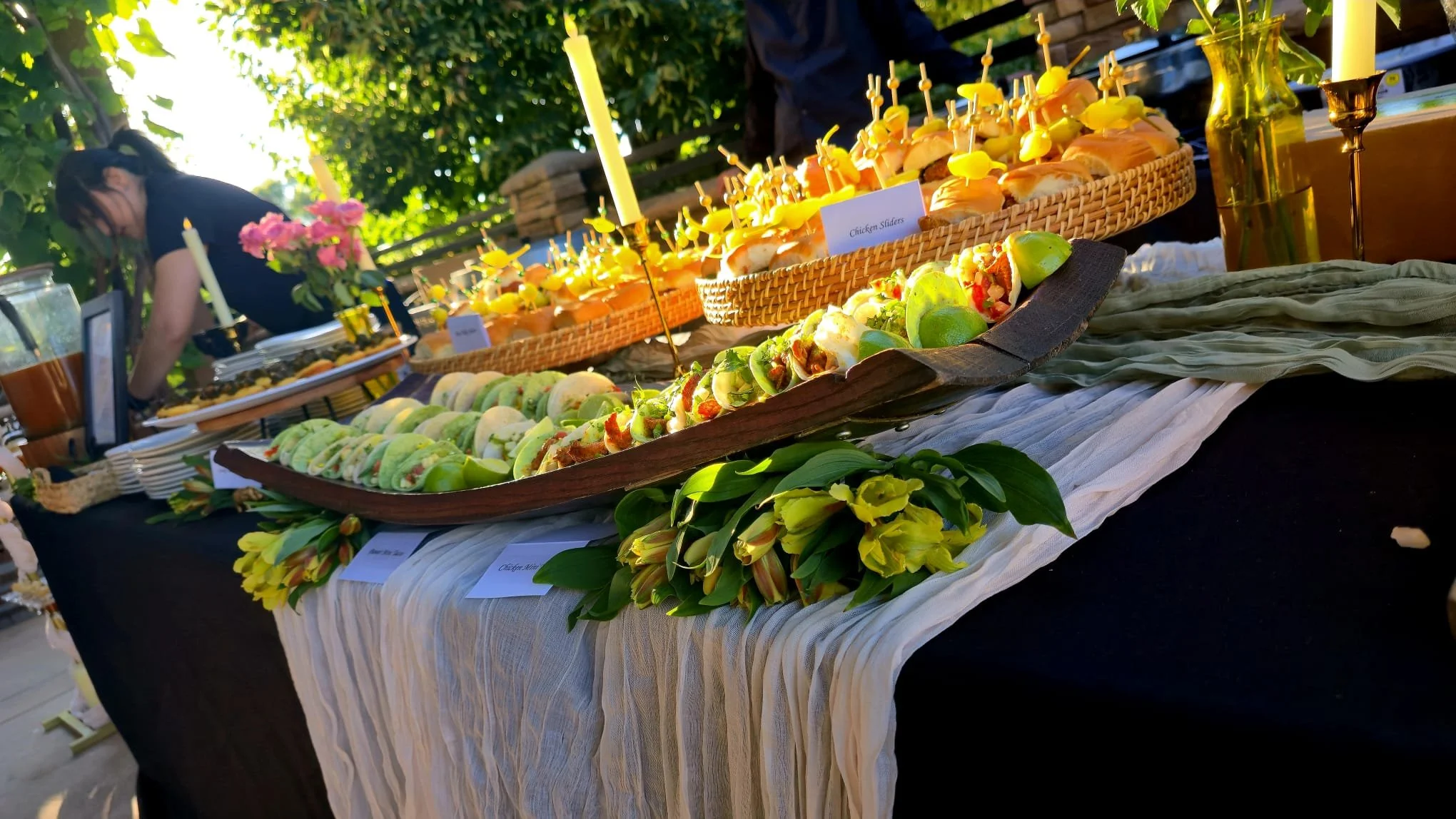 Outdoor catering setup with shared dishes for a private event