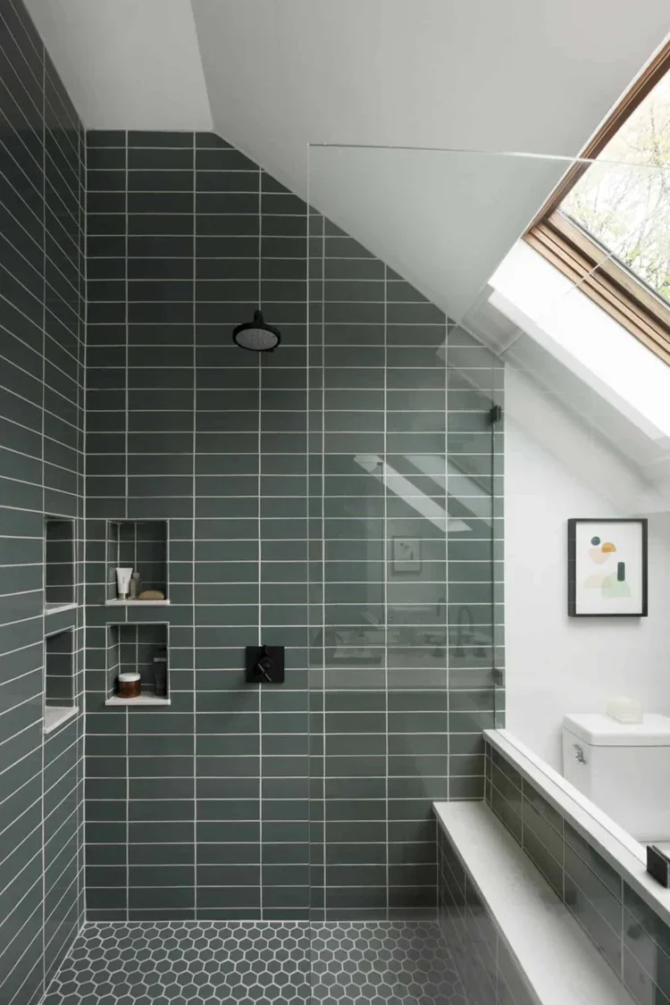 We expanded the size of the shower by 18” to accommodate a bench and centered the glass panels rather than have the door left of center as it was before.