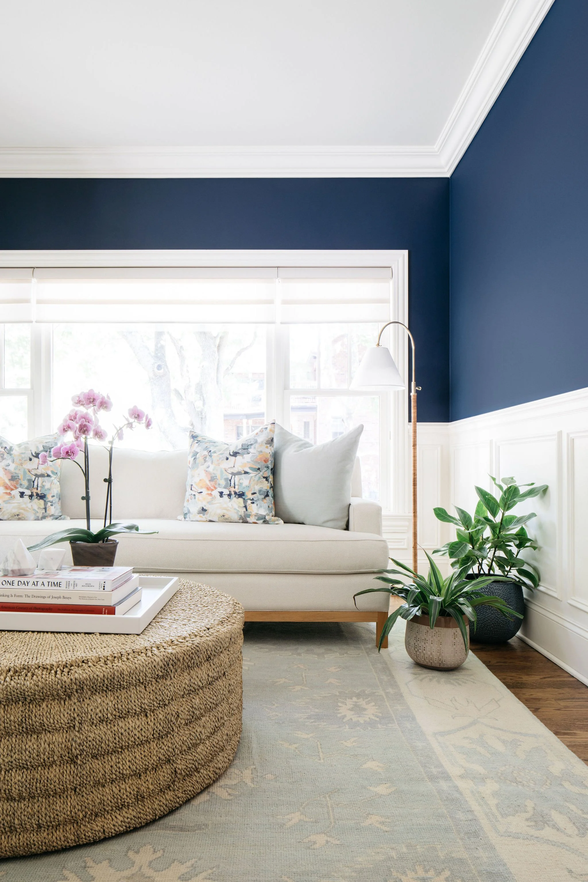 Beautiful living space with light furniture and blue accent walls.