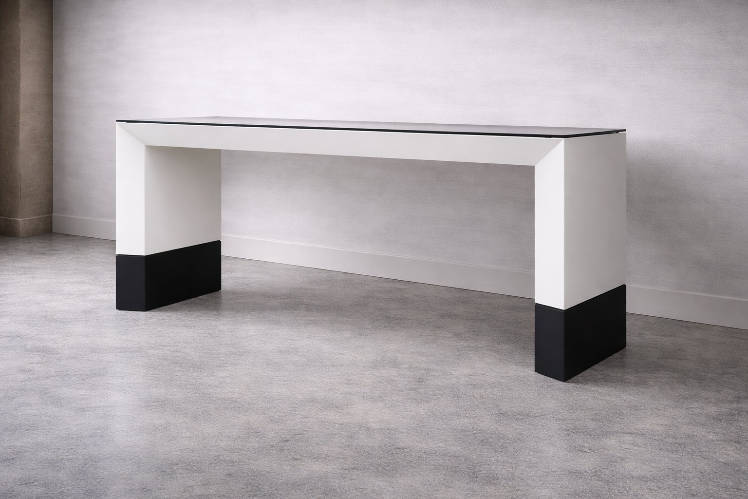 Modern white and black console table in minimalist room with gray carpet and plain wall.