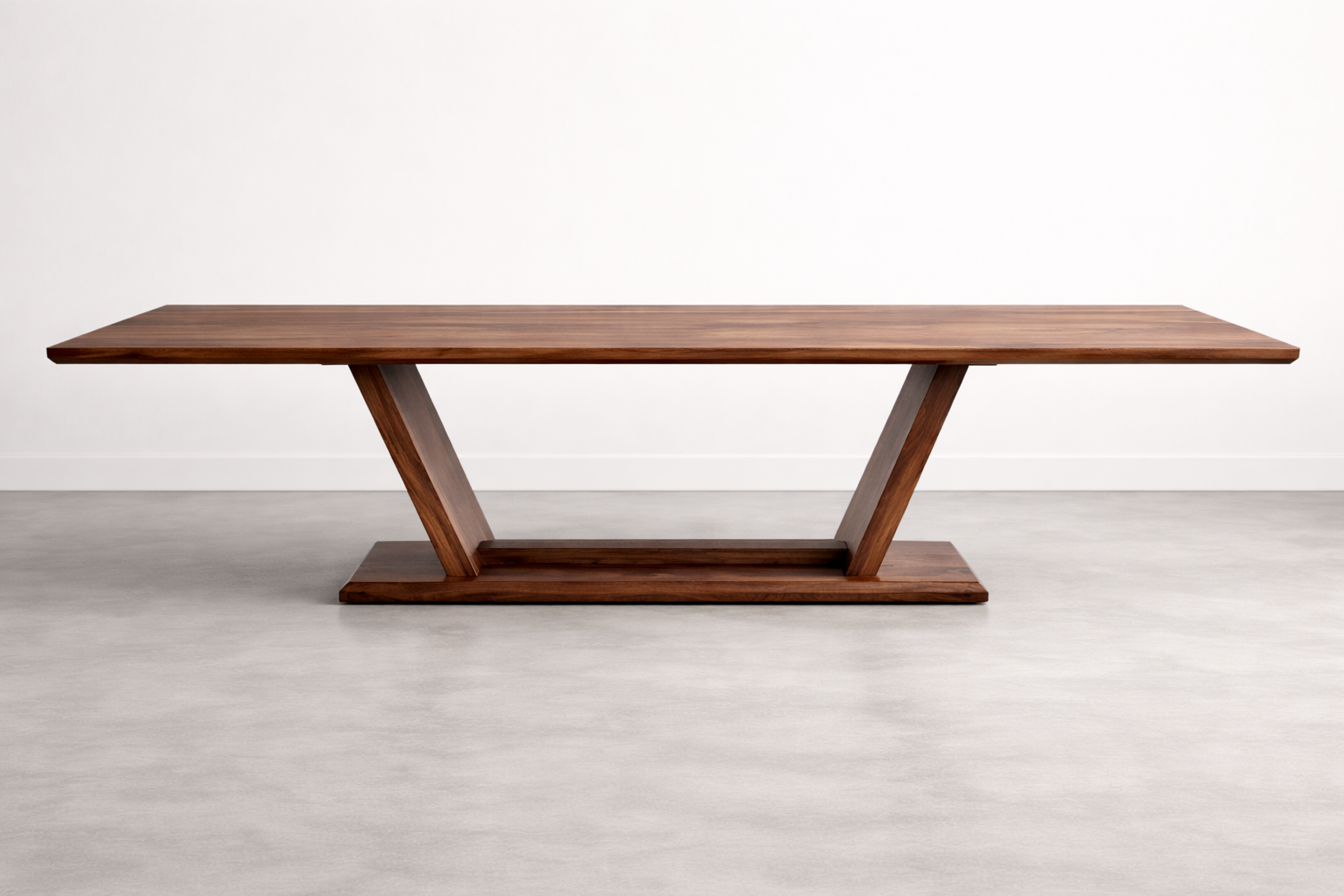 A wooden table with an angular, modern design against a plain white wall.