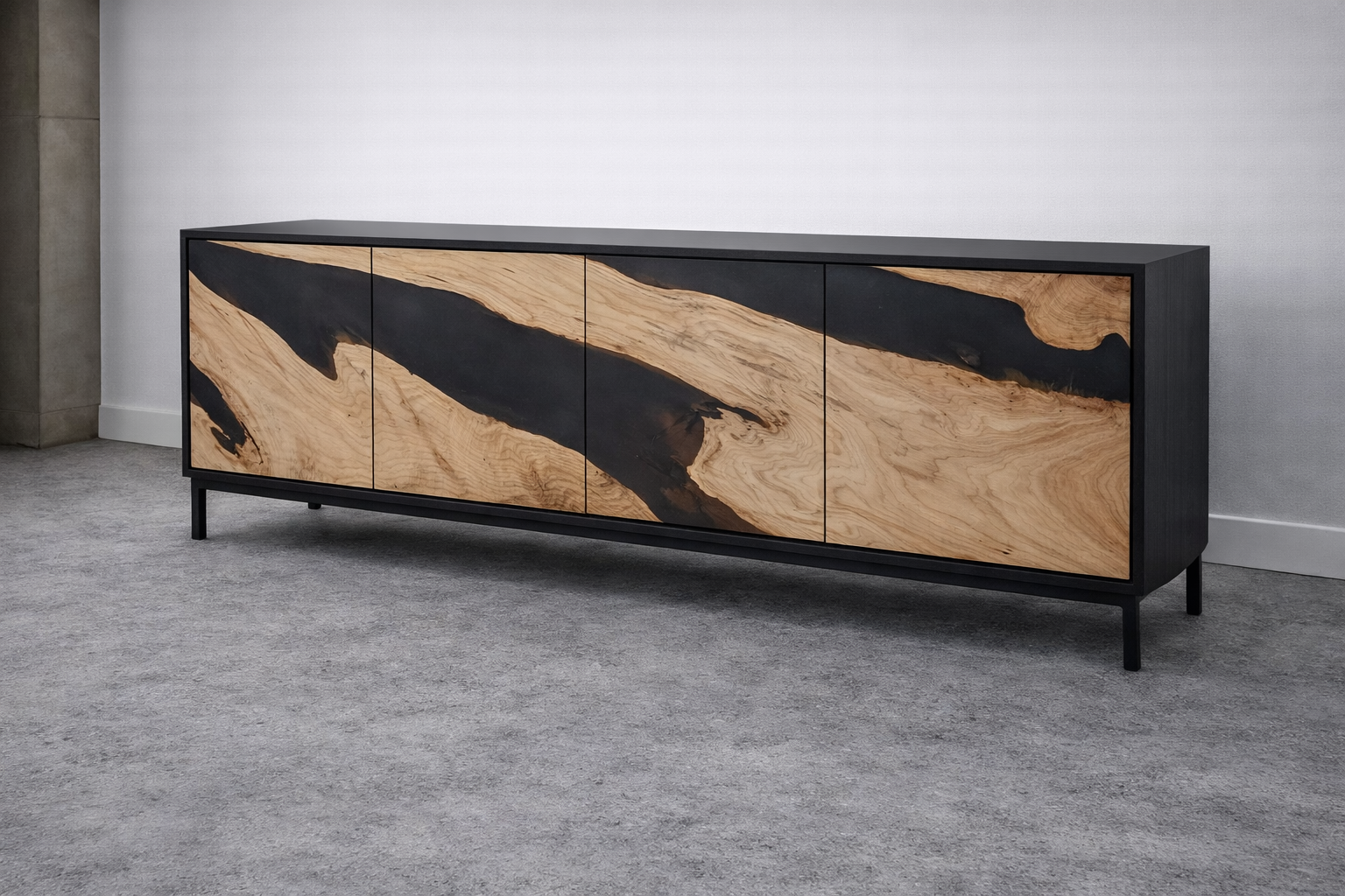 Modern black and wood sideboard with a natural wood grain pattern and black accents against a light-colored wall and carpeted floor.