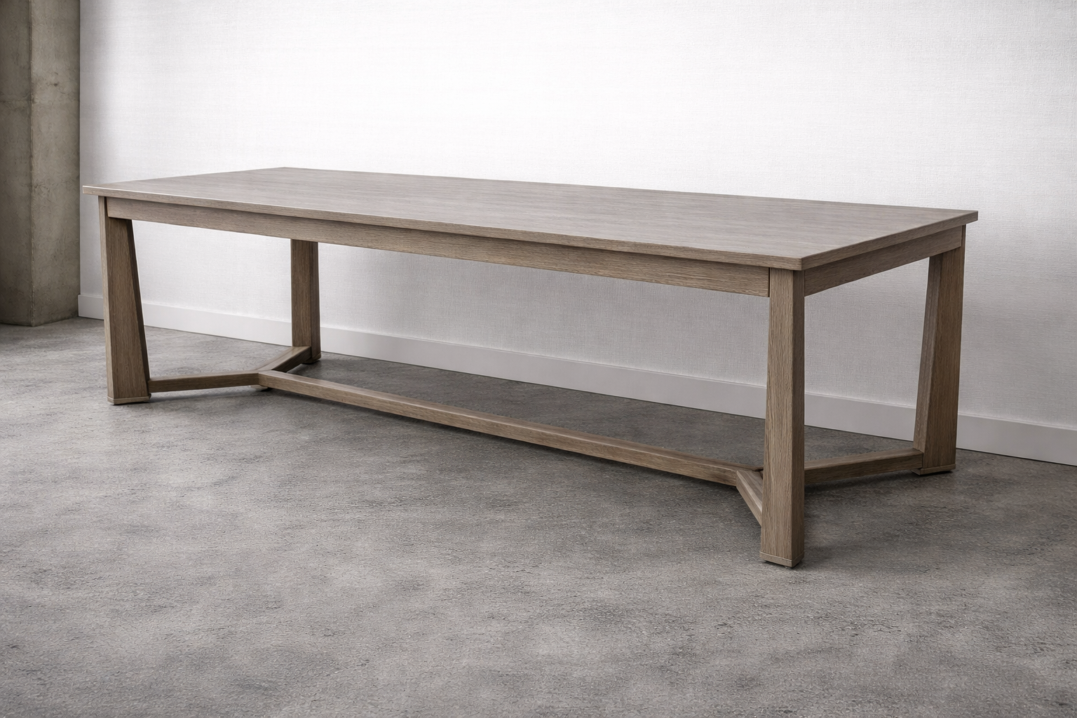 A wooden bench with a light oak finish against a plain white wall and gray carpeted floor.